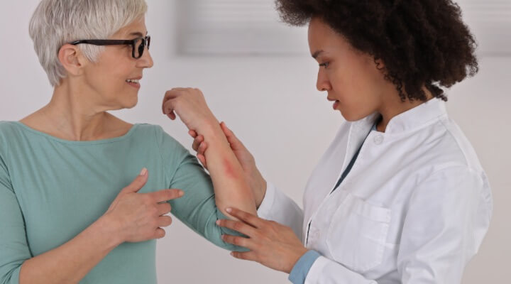 dermatologist inspecting arm