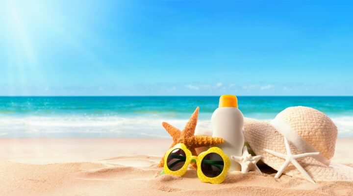 shells and sunglasses displayed on sunny beach