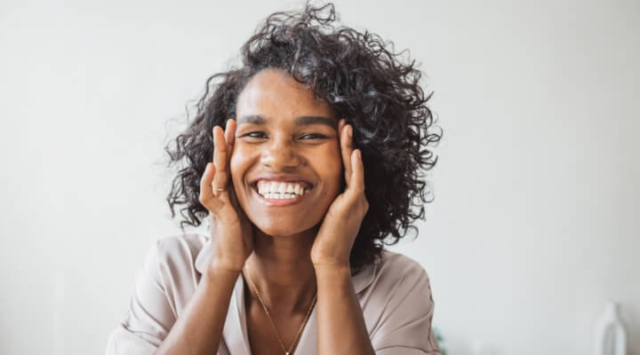 mature woman smiling touching face